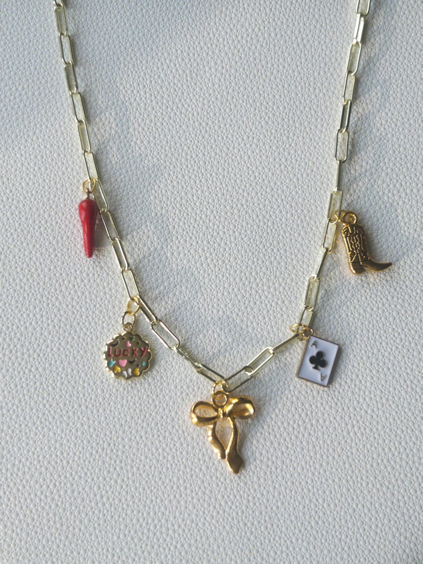 Gold bow charm necklace